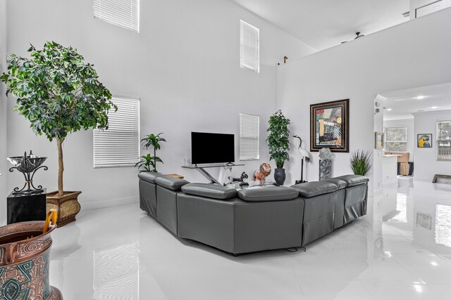 853 Gazetta Way, West Palm Beach, FL 33413 - living area featuring a towering ceiling and stairway