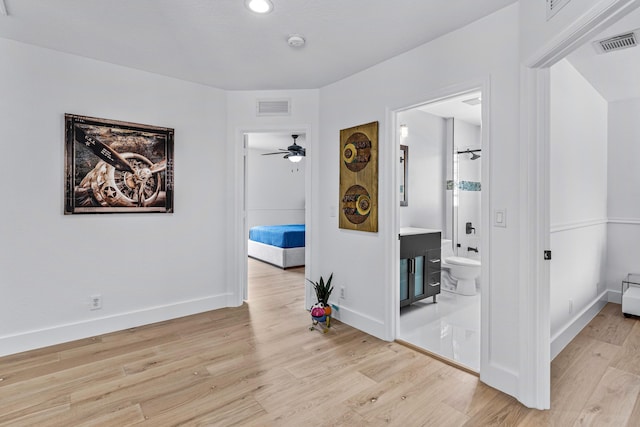 hallway with light hardwood / wood-style floors