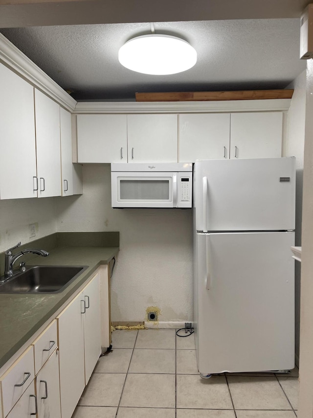 129 Ventnor I Unit 129, Deerfield Beach, FL 33442 - kitchen with white appliances, a sink, white cabinets, a textured ceiling, and light tile patterned floors