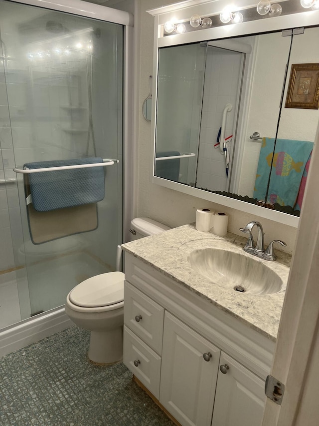 bathroom featuring a stall shower, vanity, and toilet