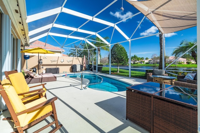 view of pool with a lanai, a water view, a fenced in pool, and a patio