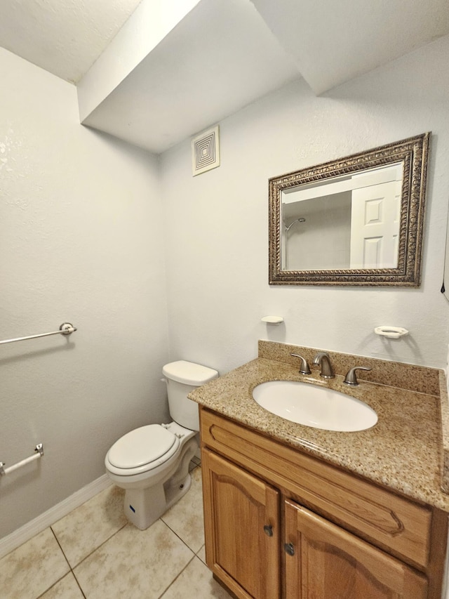 bathroom featuring tile patterned flooring, toilet, vanity, visible vents, and baseboards