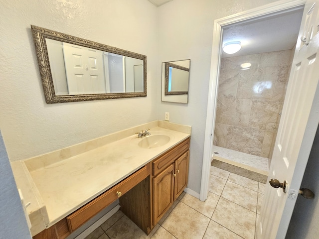 full bath with a shower stall, vanity, and tile patterned floors