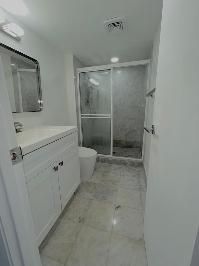 full bathroom with marble finish floor, visible vents, toilet, a shower stall, and vanity