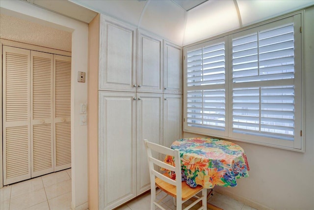 dining area featuring light tile patterned flooring