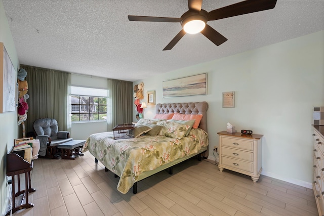 10137 S 42nd Ave S, Boynton Beach, FL 33436 - bedroom featuring light wood finished floors, a ceiling fan, baseboards, and a textured ceiling