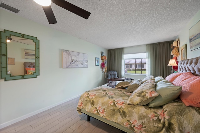10137 S 42nd Ave S, Boynton Beach, FL 33436 - bedroom featuring wood finished floors, visible vents, a ceiling fan, baseboards, and a textured ceiling