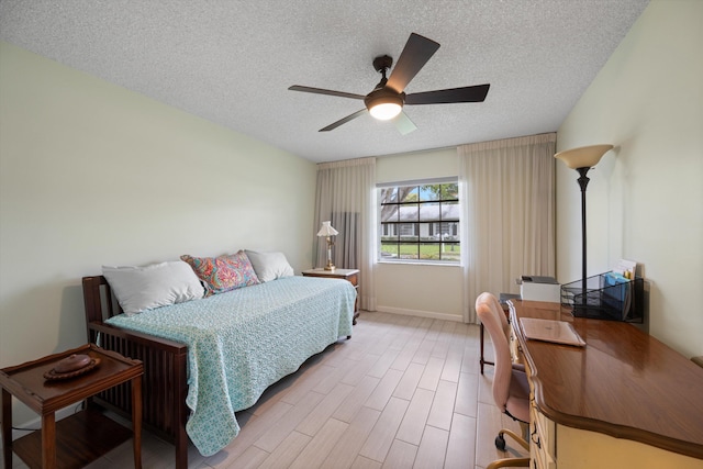 10137 S 42nd Ave S, Boynton Beach, FL 33436 - bedroom featuring wood finished floors, a textured ceiling, a ceiling fan, and baseboards