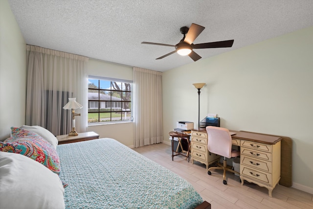 10137 S 42nd Ave S, Boynton Beach, FL 33436 - bedroom featuring a ceiling fan, baseboards, a textured ceiling, and light wood-style floors
