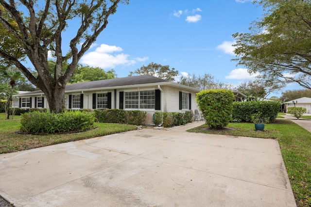 10137 S 42nd Ave S, Boynton Beach, FL 33436 - ranch-style house with brick siding and a front lawn