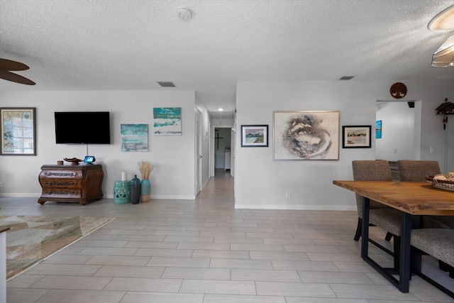 10137 S 42nd Ave S, Boynton Beach, FL 33436 - dining room with baseboards, visible vents, a textured ceiling, and ceiling fan