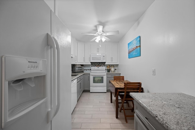10137 S 42nd Ave S, Boynton Beach, FL 33436 - kitchen with a ceiling fan, white appliances, gray cabinetry, white cabinets, and light stone countertops