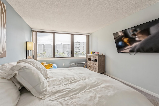 carpeted bedroom with a textured ceiling