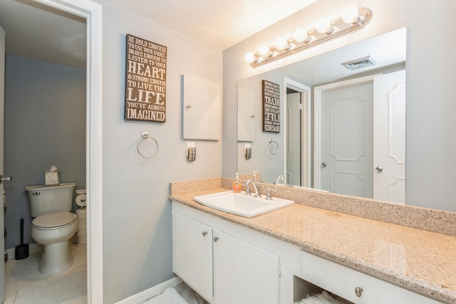 bathroom with vanity and toilet