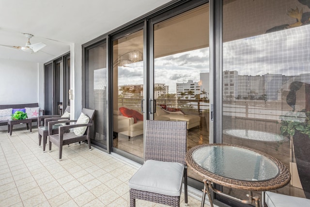 balcony with an outdoor hangout area, ceiling fan, and a patio