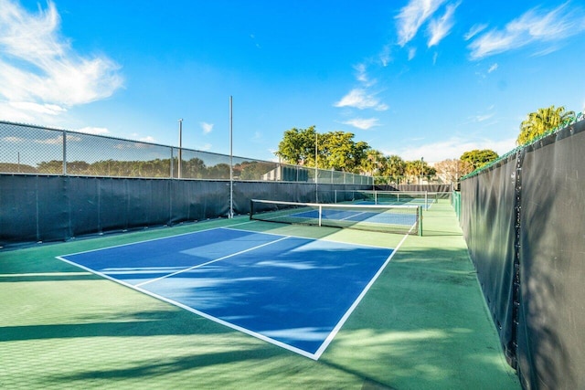 view of tennis court with fence