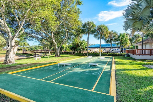 view of community featuring a lawn and shuffleboard