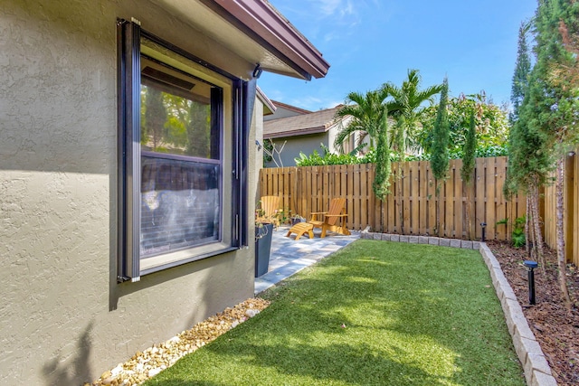 view of yard with fence and a patio