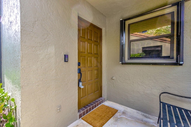 property entrance featuring stucco siding