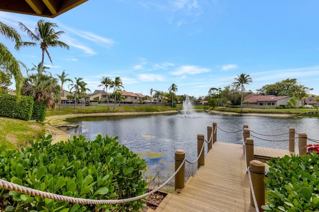 view of dock with a water view and a residential view