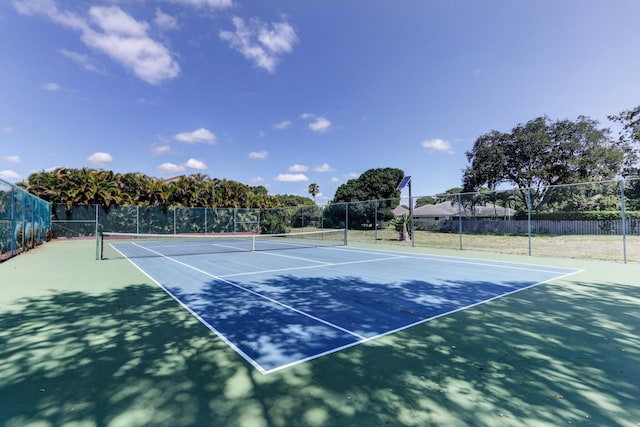 view of sport court featuring fence