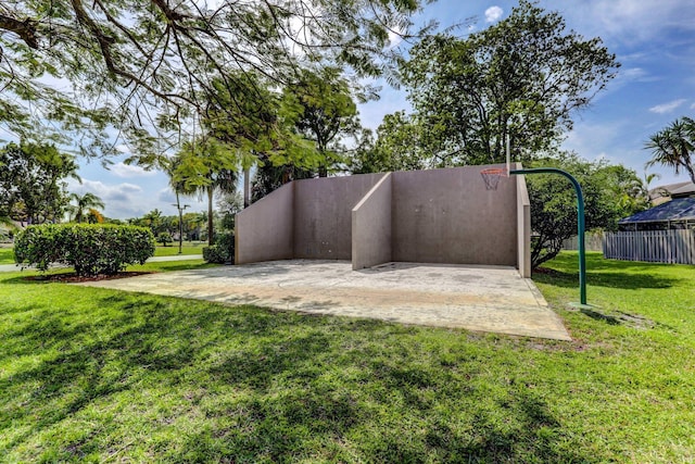 view of property's community with a yard and fence