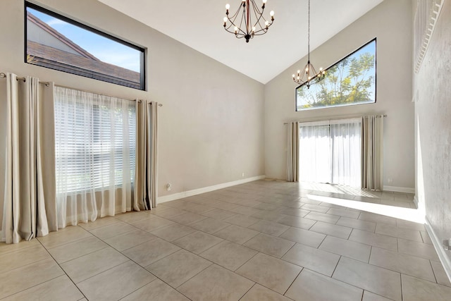 spare room featuring light tile patterned floors, baseboards, a chandelier, and high vaulted ceiling