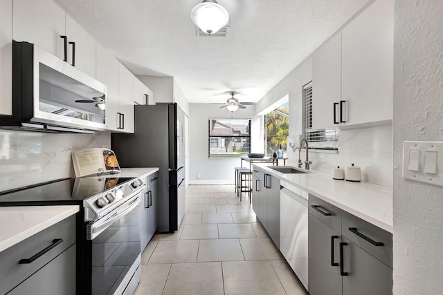 kitchen featuring white cabinetry, appliances with stainless steel finishes, and light countertops