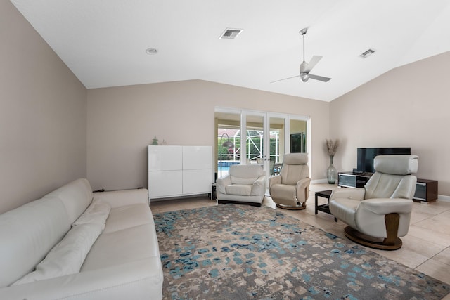 living area with light tile patterned floors, visible vents, ceiling fan, vaulted ceiling, and baseboards