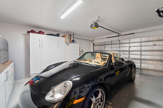 garage featuring a garage door opener and baseboards