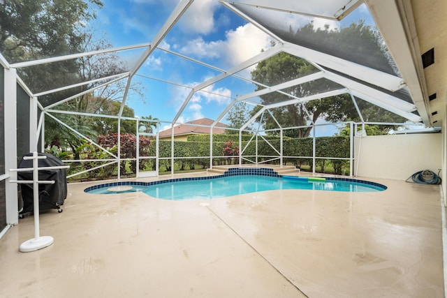 view of swimming pool featuring a lanai, a patio area, a fenced in pool, and area for grilling