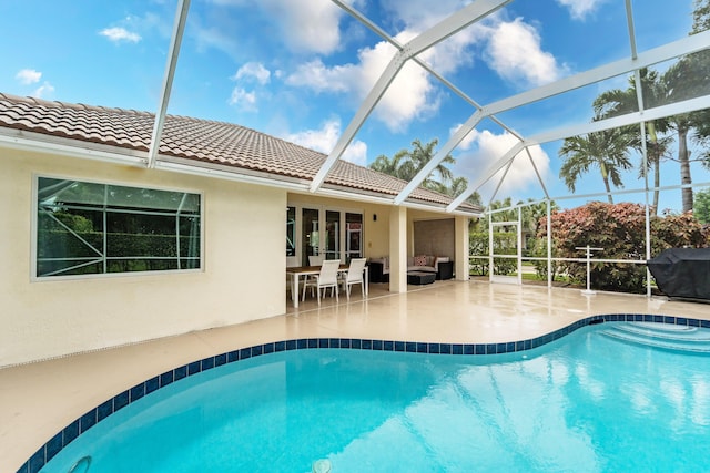 outdoor pool featuring a lanai, a patio area, and outdoor lounge area