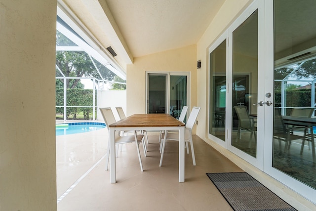 exterior space featuring vaulted ceiling and french doors