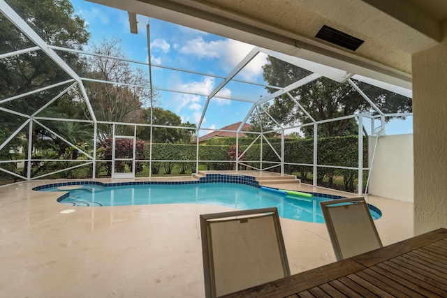 view of swimming pool with glass enclosure, a patio, and a fenced in pool