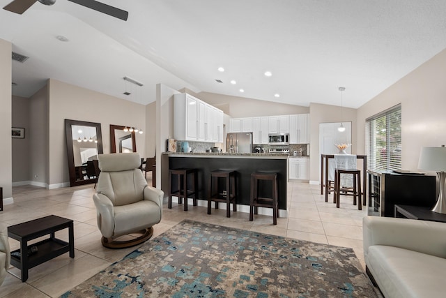 living room with light tile patterned floors, baseboards, visible vents, a ceiling fan, and lofted ceiling