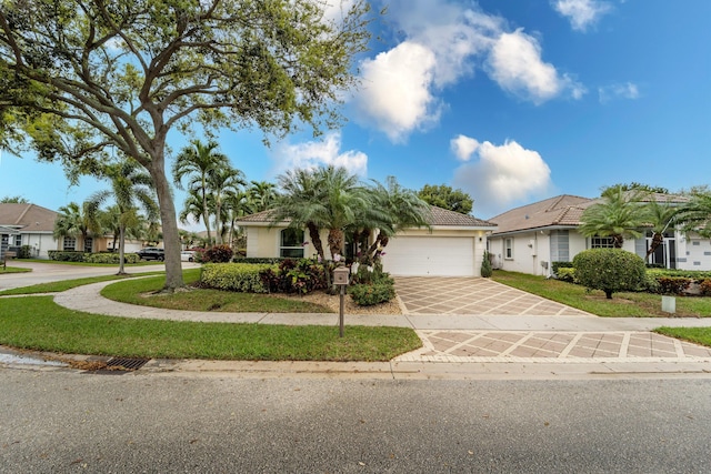 view of front facade featuring a garage, a residential view, driveway, and stucco siding