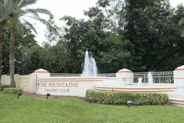 community sign featuring a lawn