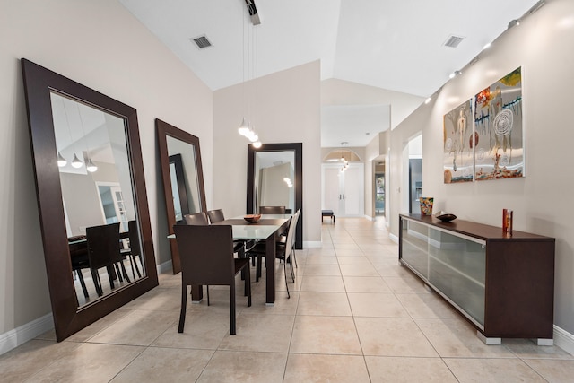 dining area featuring visible vents, vaulted ceiling, baseboards, and light tile patterned flooring