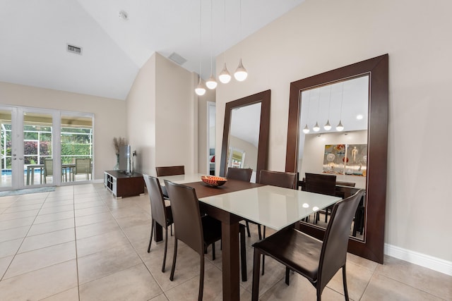 dining area featuring french doors, light tile patterned floors, lofted ceiling, visible vents, and baseboards