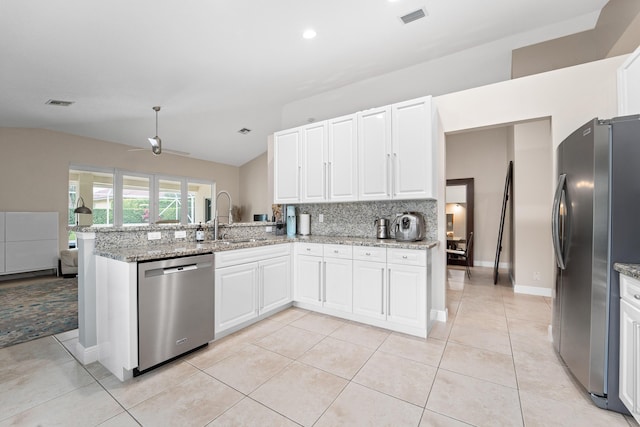 kitchen featuring visible vents, light stone counters, a peninsula, stainless steel appliances, and white cabinetry