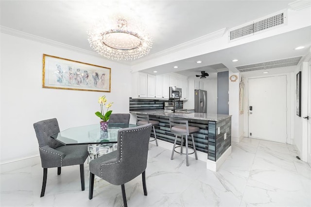 dining room with marble finish floor, a notable chandelier, visible vents, and crown molding