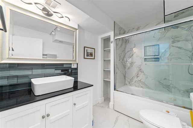 full bath with marble finish floor, visible vents, toilet, combined bath / shower with glass door, and vanity