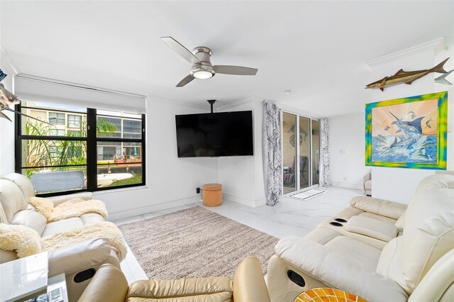 living room with marble finish floor, ceiling fan, and baseboards