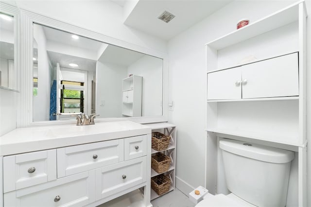 half bathroom featuring visible vents, vanity, toilet, and baseboards