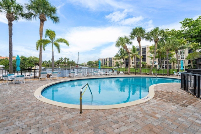 pool featuring a patio and fence