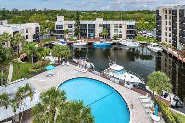 community pool with a water view and fence