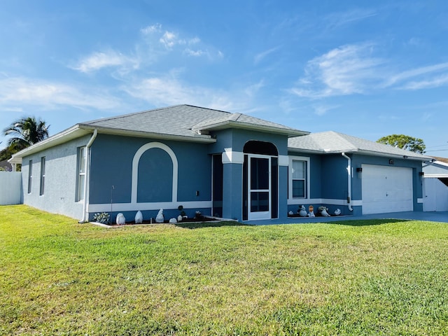 view of front of property with a garage, a front yard, and stucco siding