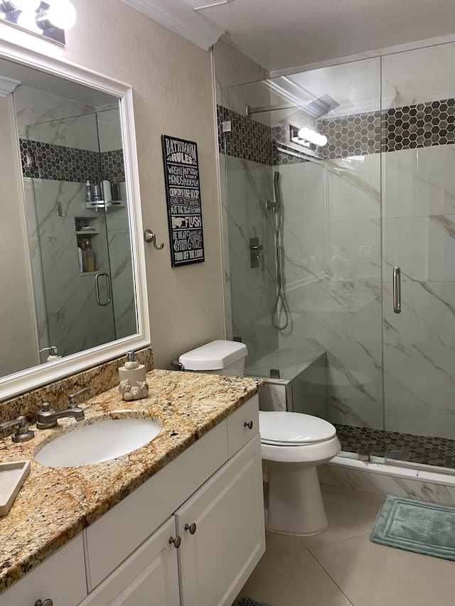 full bathroom with toilet, vanity, and a marble finish shower