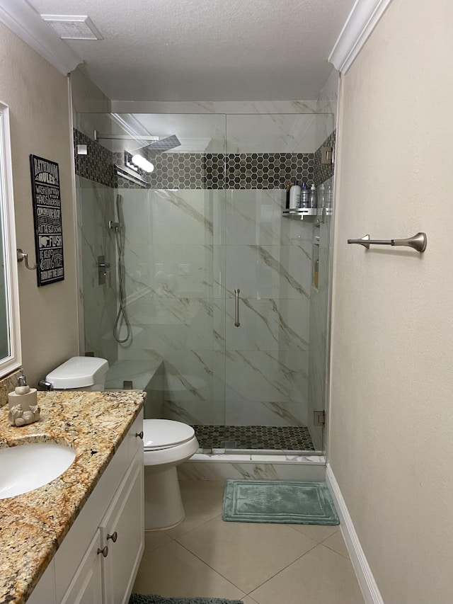 full bath with a marble finish shower, baseboards, toilet, tile patterned floors, and vanity