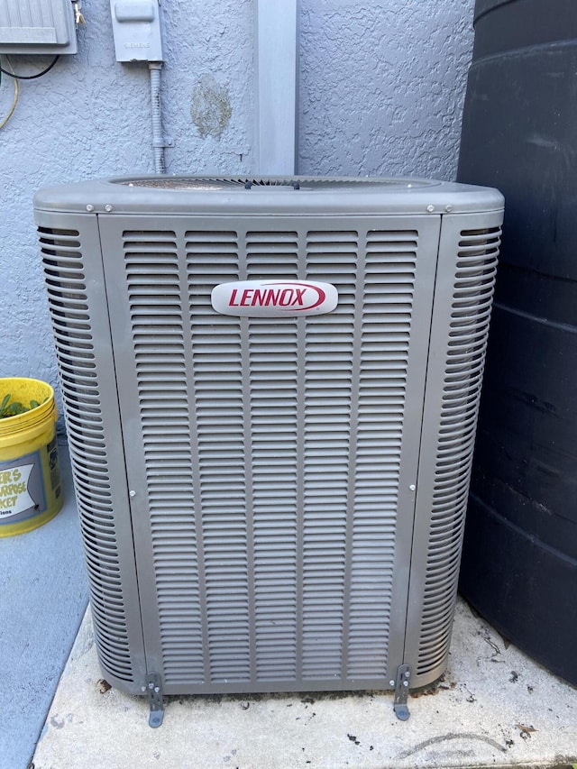 details with central AC unit and stucco siding